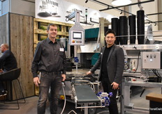 Hans Lütmann of Klarmann and Lun Li of Mayer in front of the new potting machine TM 24 32 D which van switch between double and single pots. Klarmann is The Mayer distributed in north Germany.